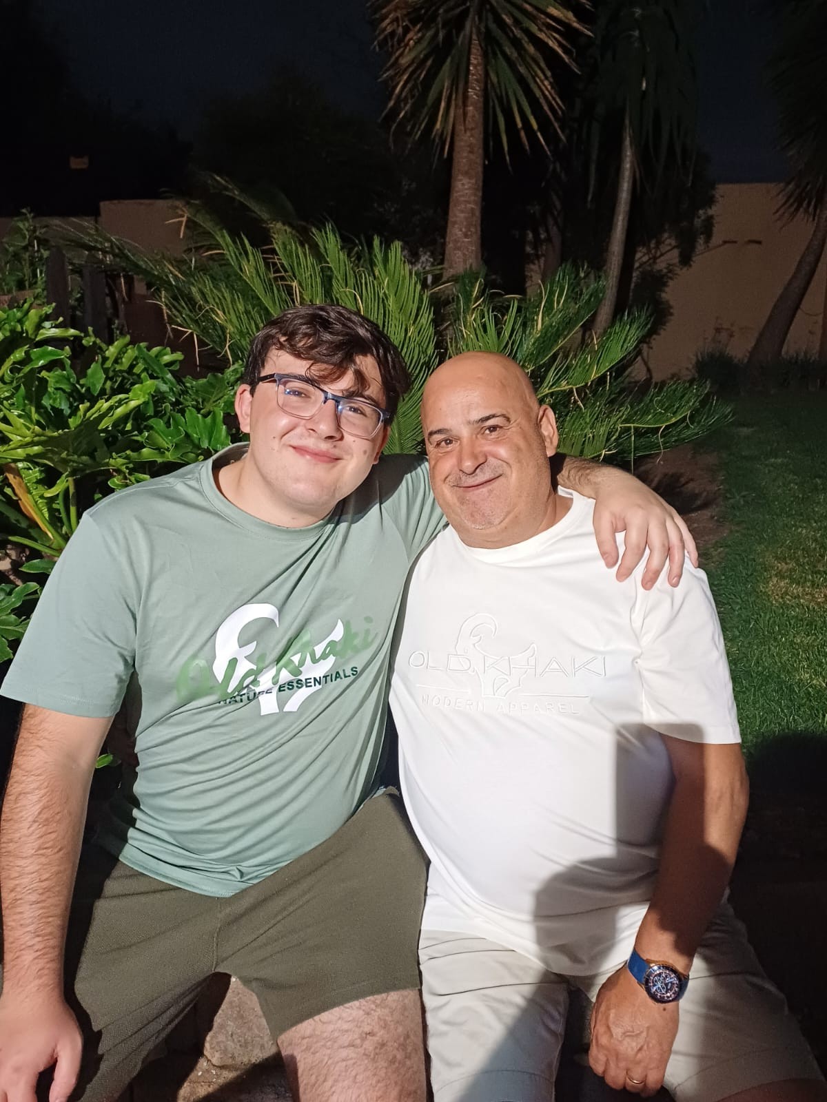 Dad and his son with their arms around each other in the garden
