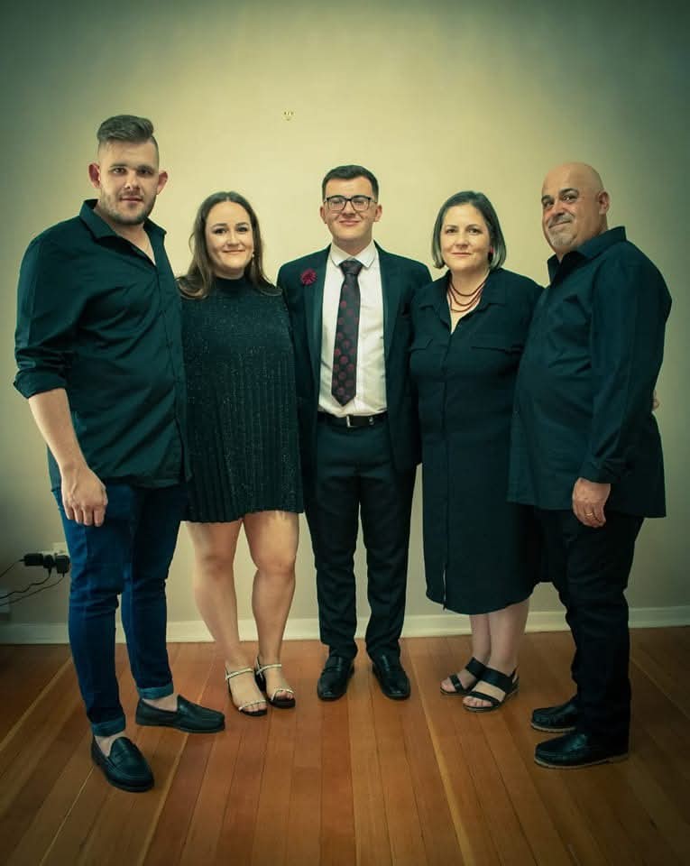 Five family members dressed up and standing together