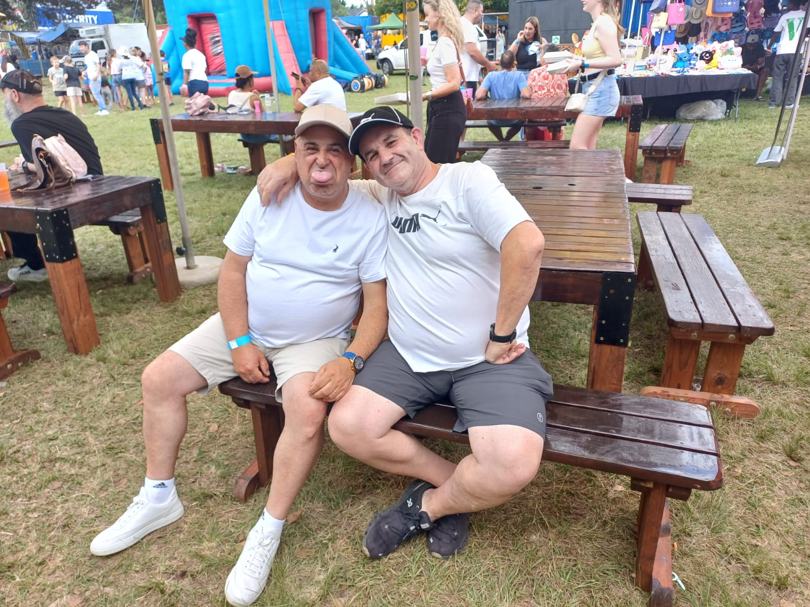 Dad and a friend laughing together at an outdoor festival