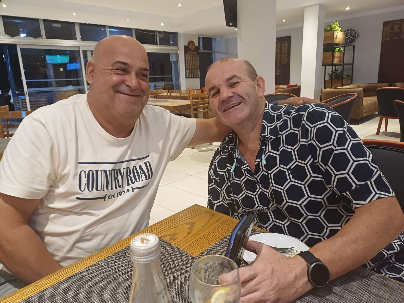 Dad and a friend smiling over dinner