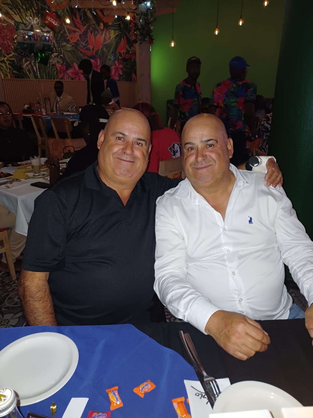 Dad and a friend smiling together at a restaurant